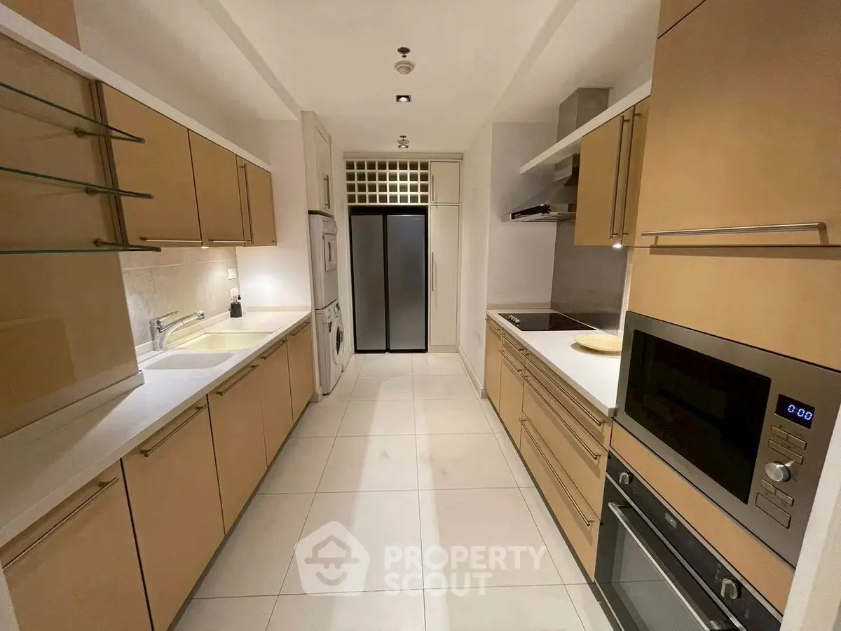 Modern kitchen with sleek cabinetry and built-in appliances in a stylish apartment.