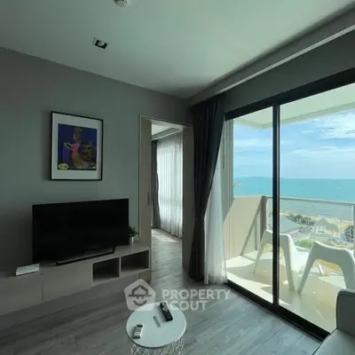 Stunning beachfront living room with modern decor and ocean view balcony.