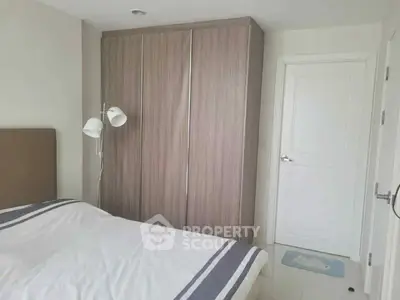 Modern bedroom with sleek wardrobe and cozy bed in a minimalist design.