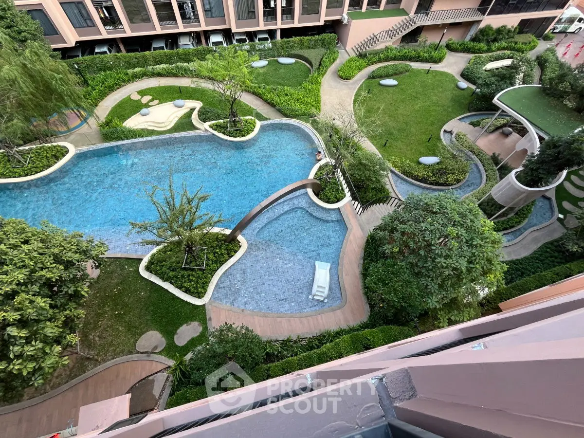 Stunning aerial view of modern residential pool and lush garden landscape.