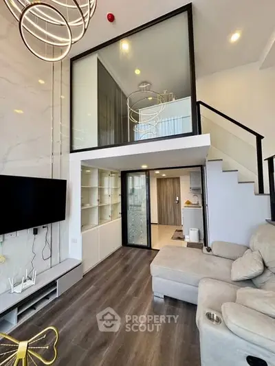 Modern loft-style living room with high ceilings and stylish decor