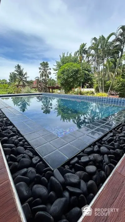 Stunning outdoor pool with lush tropical garden view