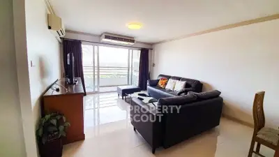 Spacious living room with modern furniture and balcony view