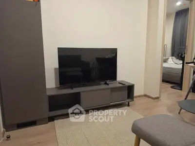 Modern living room with sleek TV stand and cozy bedroom view, perfect for urban living.