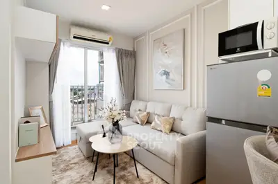 Modern living room with cozy sofa, stylish decor, and balcony view in a chic apartment.