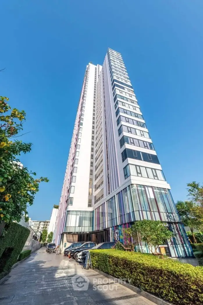 Stunning modern high-rise building with sleek design and vibrant facade, perfect for urban living.