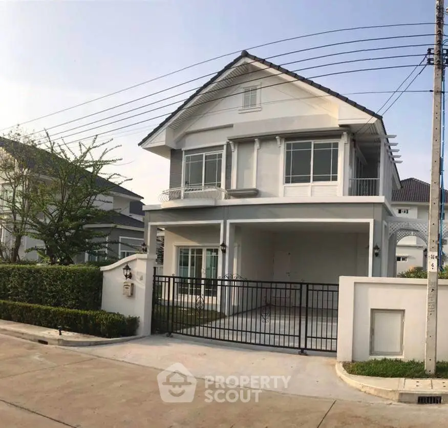 Charming two-story house with modern design and spacious driveway in a serene neighborhood.