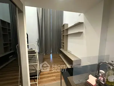 Modern compact living space with loft bed and sleek shelving