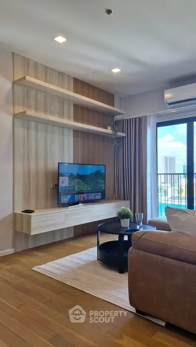 Modern living room with stylish TV setup and balcony view