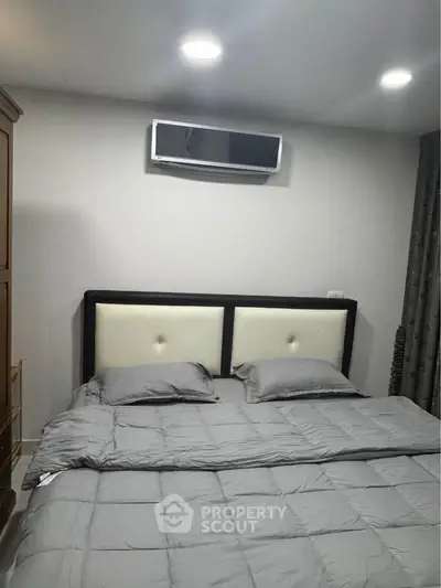 Modern bedroom with sleek design and air conditioning unit, perfect for comfort and relaxation.
