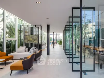 Luxurious modern living room with floor-to-ceiling windows and stylish furniture