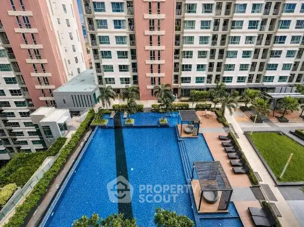 Luxurious condominium with stunning pool and lush greenery, perfect for modern urban living.