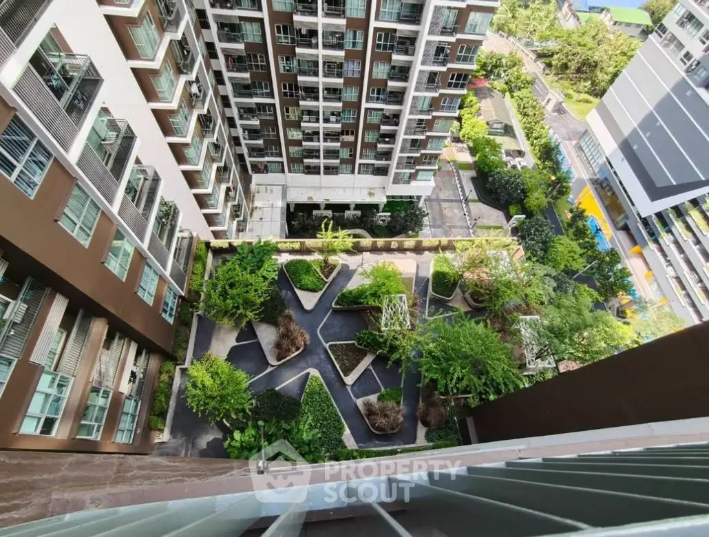 Stunning aerial view of modern apartment complex with lush green garden