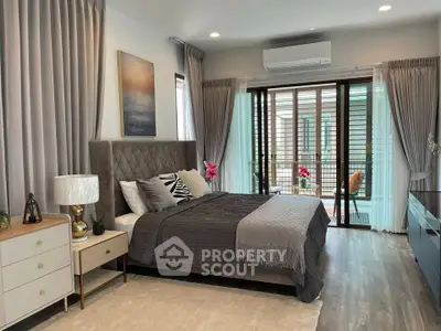 Luxurious bedroom with elegant decor and balcony access in modern home