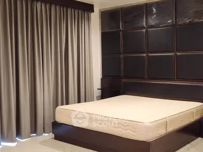 Spacious bedroom with elegant curtains and modern headboard design