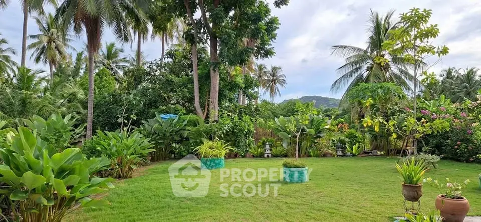 Lush tropical garden with vibrant greenery and scenic mountain views, perfect for serene outdoor living.