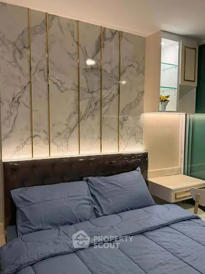 Luxurious bedroom with elegant marble accent wall and plush bedding