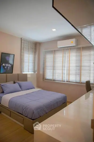 Modern bedroom with stylish decor and ample natural light