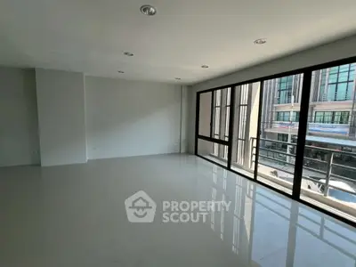 Spacious modern living room with large windows and natural light