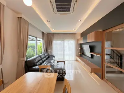 Modern living room with sleek design, leather sofa, and large windows for natural light.