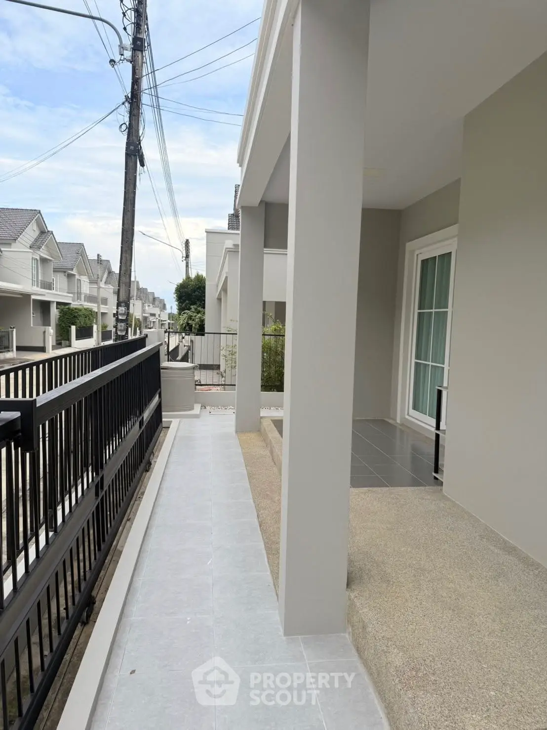 Modern residential exterior with sleek design and spacious walkway
