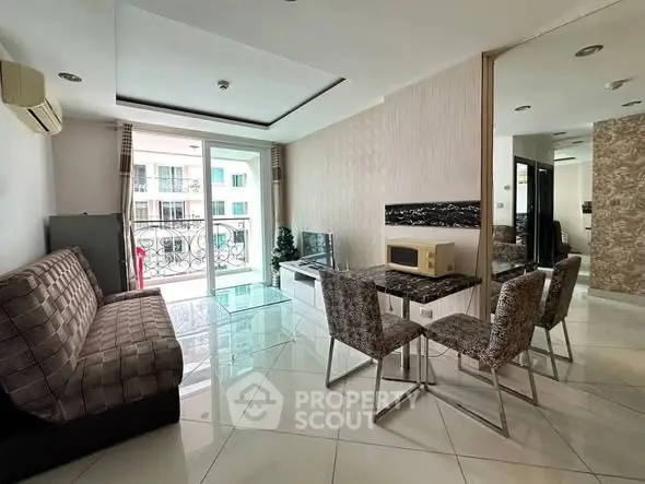 Modern living room with balcony and stylish dining area in a contemporary apartment.