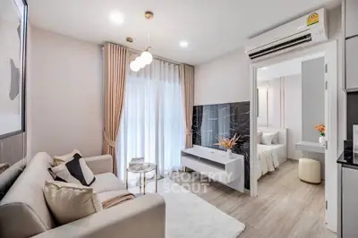 Modern living room with elegant decor and open view to bedroom