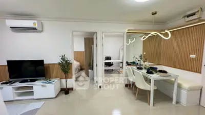 Modern apartment interior with open living and dining area, featuring stylish decor and natural lighting.