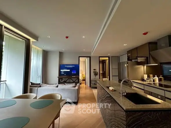 Luxurious open-plan kitchen and living room with modern design and ample natural light.