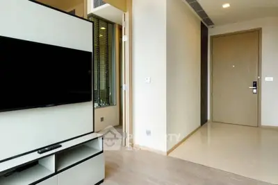 Modern apartment entrance with sleek TV unit and minimalist design.