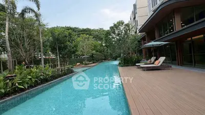Luxurious apartment complex with stunning pool and lush greenery