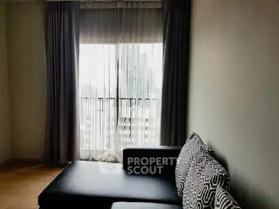 Modern living room with stylish sofa and large window view.