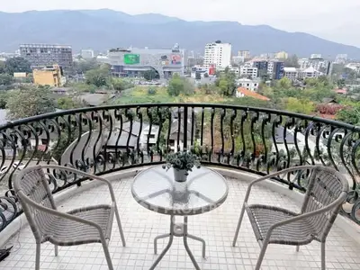 Stunning balcony view overlooking cityscape and mountains, perfect for relaxation and enjoying the scenery.