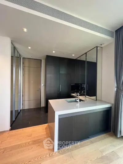 Modern kitchen with sleek design and open layout, featuring a stylish island and high-end appliances.