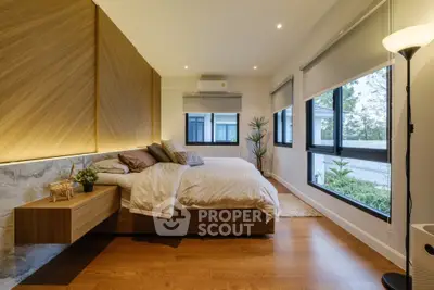 Luxurious modern bedroom with large windows and elegant wooden flooring.