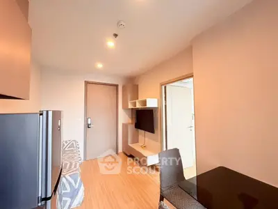 Modern living room with stylish furniture and wall-mounted TV in a cozy apartment.