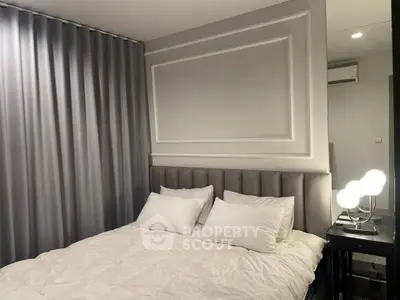 Elegant bedroom with plush headboard and modern lighting