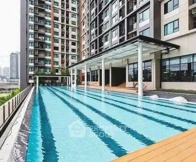 Luxurious apartment complex with a stunning outdoor pool and modern architecture.