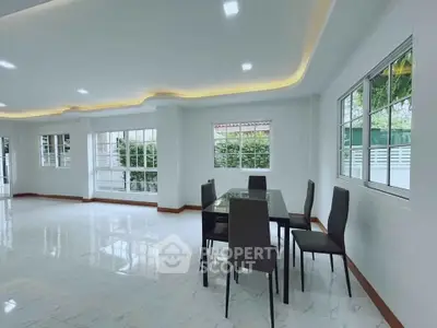 Spacious modern dining area with elegant lighting and large windows