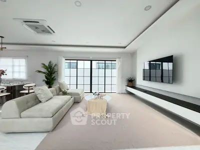 Spacious modern living room with elegant decor and large windows