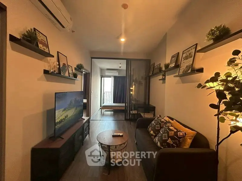 Cozy living room with modern decor and open view to bedroom