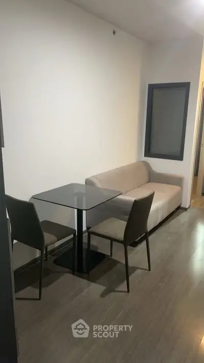 Modern living room with sleek glass table and cozy sofa