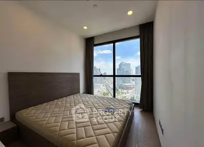 Modern bedroom with stunning city view from large window, featuring a minimalist design and cozy atmosphere.