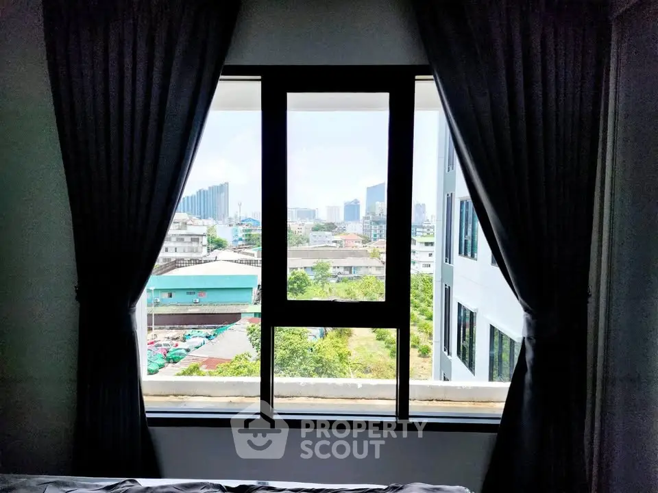 Stunning cityscape view from a modern apartment window, showcasing urban living at its finest.