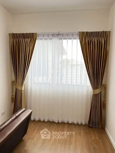 Elegant living room corner with luxurious curtains and wooden flooring