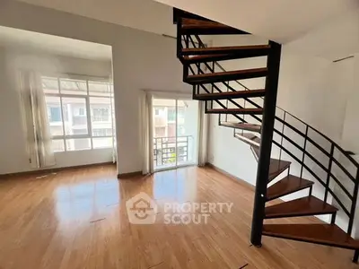 Spacious interior with modern spiral staircase and large windows