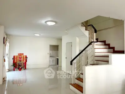 Spacious interior with modern staircase and glossy tiled flooring