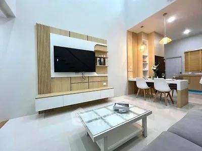 Modern living room with sleek TV setup and stylish dining area