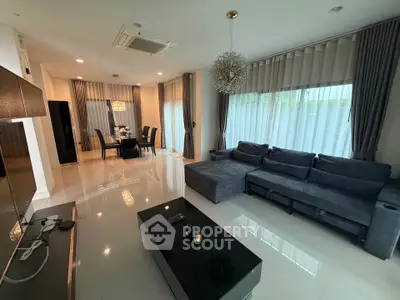Spacious modern living room with elegant decor and large windows for natural light.