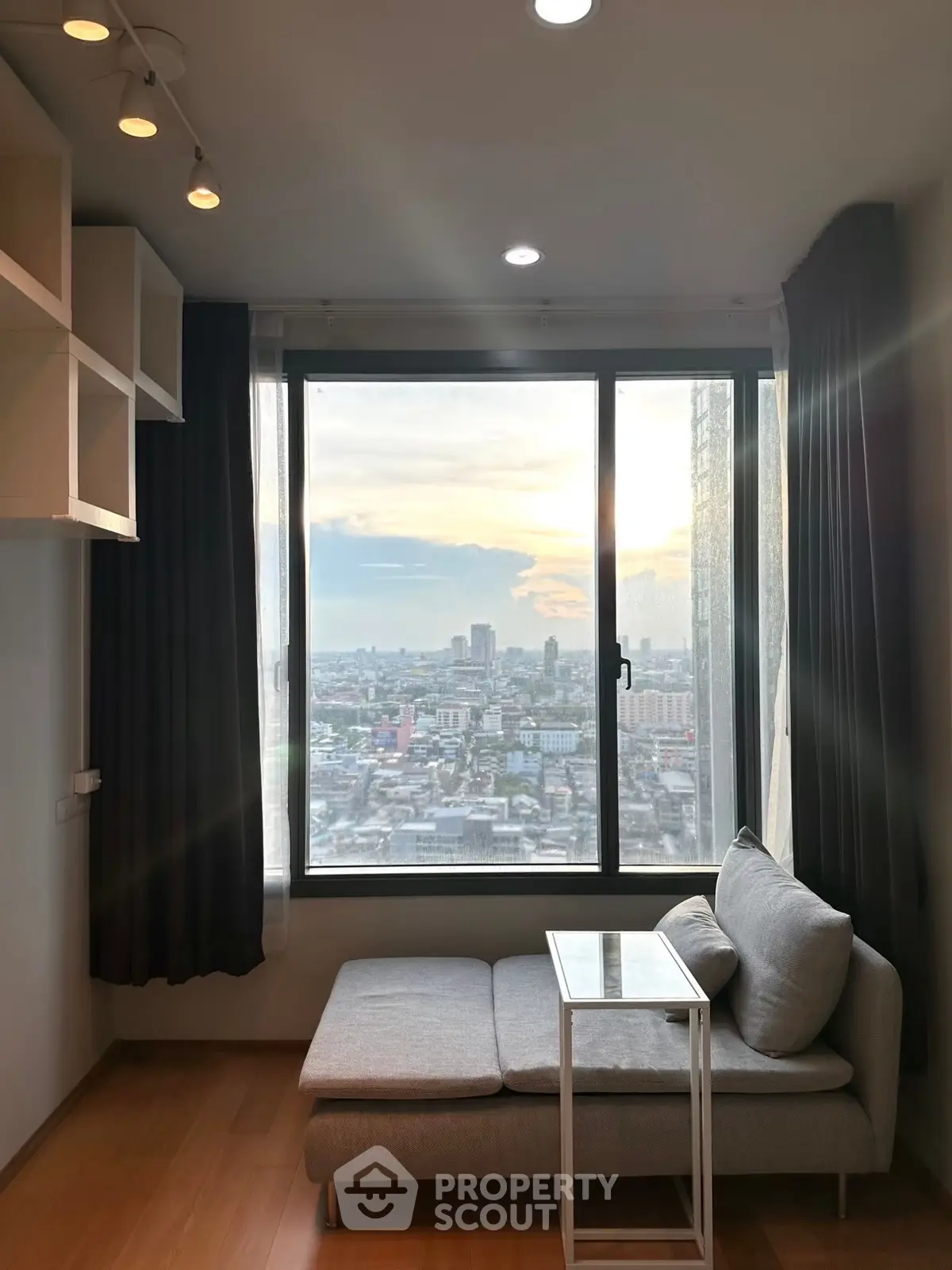 Modern living room with panoramic city view and cozy seating area
